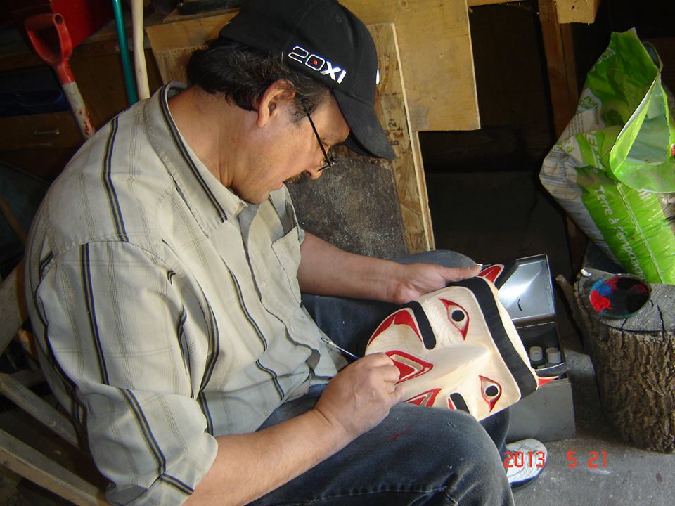 artist Emil Thibert working on a mask