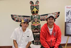 cody Mathias on the right with his totem poole