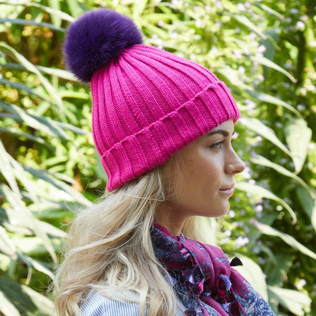 Fun hand-knit hats with interchangeable fur poms!