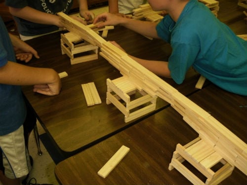 School children building a bridge with blocks