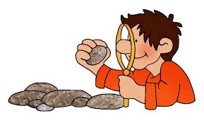 Student studying rock with magnifying glass